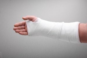 Bandages around someone's hand and wrist. 