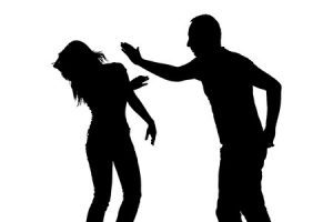 A black and white silhouette image of a man hitting someone.