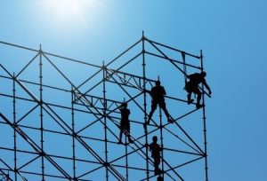 a group of men working on scaffolding