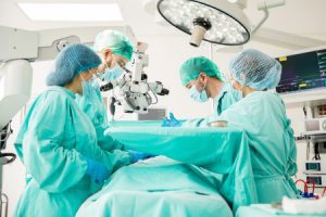 Surgeons performing a surgery in an operating room