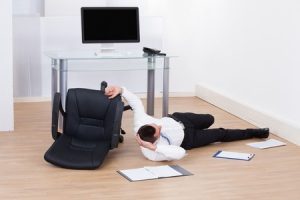 employee falls off broken chair in an office accident. 