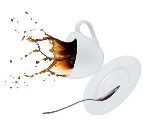 Hot drinks falling from a flying cup and saucer with a teaspoon. 