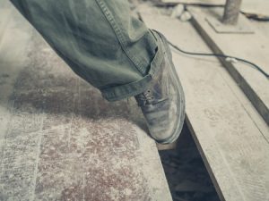 A foot slipping in an open floorboard. 