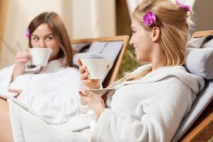 Two women sitting and relaxing inside a health spa