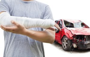 Man holding injured right arm following a car accident