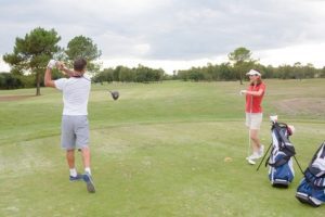 Man and woman playing golf on a golf course