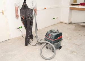 Person hoovering the floor stepping on wires.