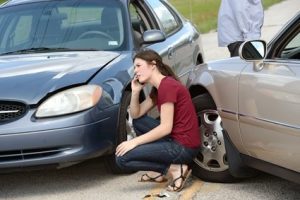 A woman enquires about how to report a car accident following a crash. 