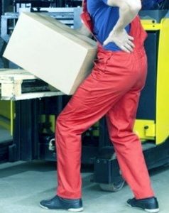 A worker lifting a heavy box depicting an example of the maximum weight limit they can lift at work.