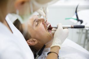 A man having his teeth checked at the dentist