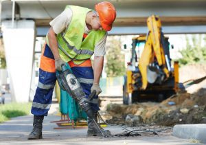 A construction worker using a jackhammer