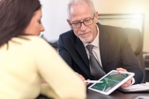 A solicitor uses a digital tablet to explain peanut allergy claims to their client.