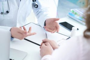 Doctors having a discussion while sat at a table