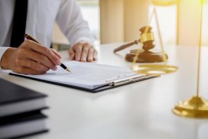 A domestic violence solicitor writing in a notepad.