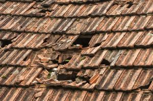 a picture of a roof with lots of holes and broken slates