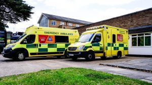 Ambulances outside of a hospital representing our guide on making a paramedic negligence claim