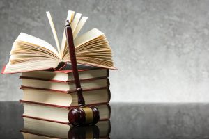 a stack of books with a wooden gavel