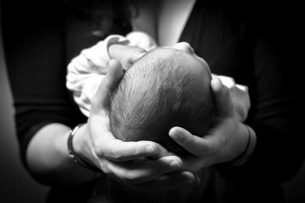 Woman holding new born baby 