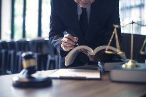 A medication negligence solicitor examining legal texts at their desk