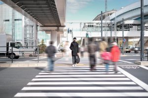 Out Of Focus Pedestrians Walking Across Zebra Crossing. 