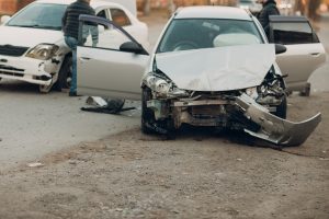 A car following a crash with a broken bonnet. 