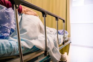 A patient lays unattended in a hospital bed