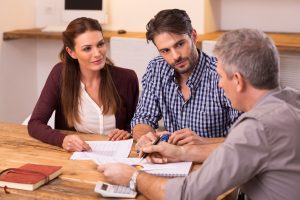 A solicitor and his clients discussing how to sue the government for a data breach.