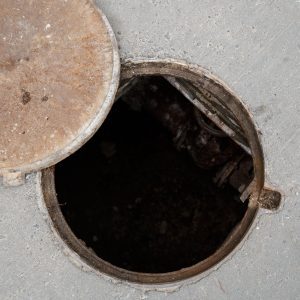 A birds-eye shot of a cover left off a manhole drain.