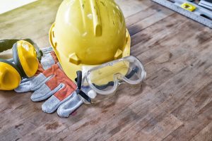 Different types of personal protective equipment, such as eye protection, a hard hat, and gloves.