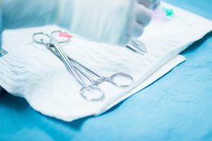 Surgical instruments sit atop sterile gauze before surgery