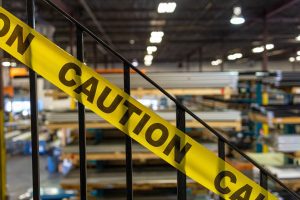 Caution tape sectioning off a dangerous area of the warehouse. 