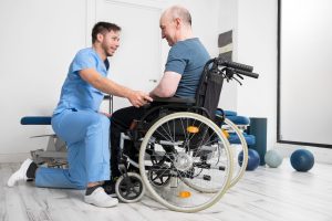 A nurse helps a man who is in a wheelchair.