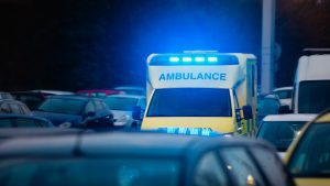 An ambulance uses its emergency lights whilst responding to a serious injury.