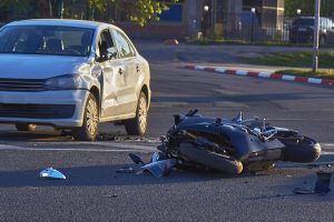 A motorcycle is laid on the floor after a collision.