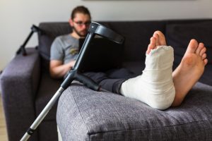 PERSON ON CRUTCHES AFTER THEIR FOOT WAS RAN OVER BY A CAR