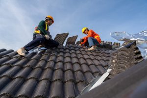 HOUSING ASSOCIATION WORKERS CARRYING OUT ROOF REPAIRS