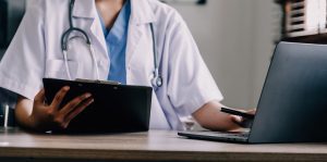 A doctor works at their desk