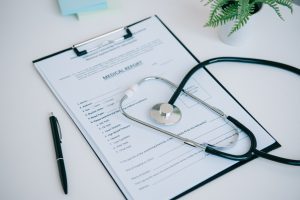 A medical report on a table with a stethoscope to represent fertility negligence.
