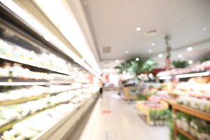 A blurred supermarket vegetable aisle.