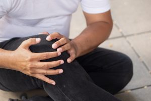 A man holds his knee after a slip and fall accident