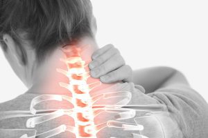 A woman experiences pain in her neck with a highlighted spine concept