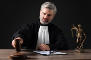 A judge banging their gavel to call for order during a court hearing