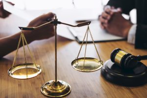 A solicitor advisinng their client how to make a complaint about misdiagnosis during a meeting 
