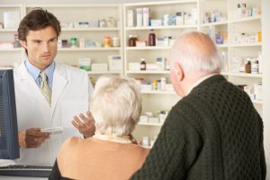 A pharmacist provides advice to patients.