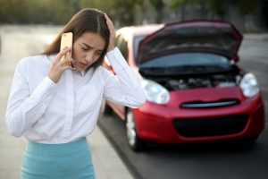 Woman on phone taking legal action after car crash.