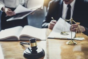 Two personal injury solicitors work on a hit and run accident claim at a desk. 