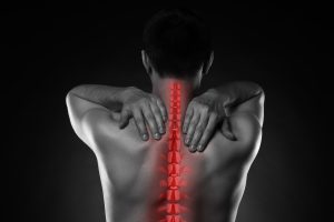 A spinal injury on a man is highlighted in red