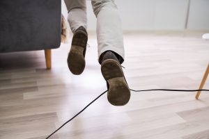 A man trips up on a trailing wire 