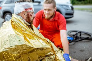 a man who suffered head injuries in a cycling accident being attended by a paramedic