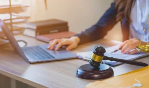An amputation claims lawyer is working on amputation claims on her laptop.